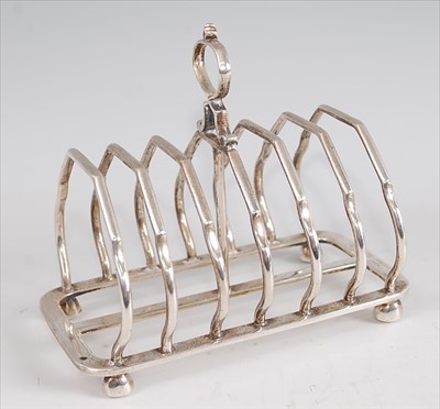 Lot 1182 - An Edwardian silver six division toast rack,...
