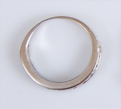 Lot 2119 - A white metal diamond half hoop eternity ring,...