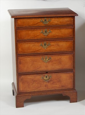 Lot 1519 - A figured walnut and crossbanded five-drawer...