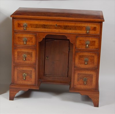 Lot 1520 - A figured walnut and crossbanded kneehole desk,...