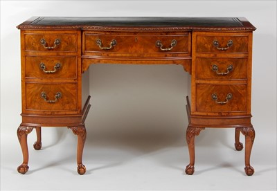 Lot 1471 - A figured walnut kneehole writing desk, circa...