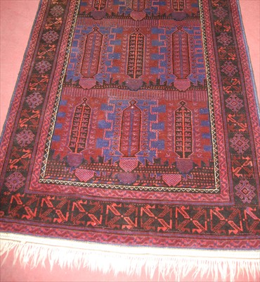 Lot 1503 - A Persian woollen rust and blue ground carpet,...