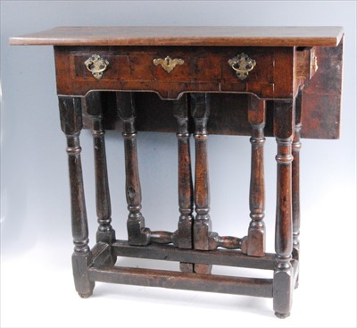 Lot 1457 - An antique oak and walnut dropflap side table,...