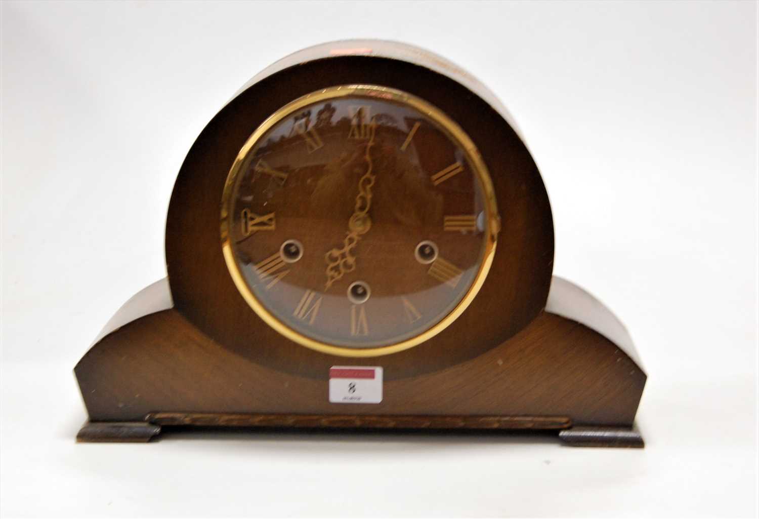 Lot 8 - A 1950s oak cased mantel clock having raised...