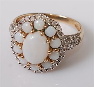 Lot 392 - A 9ct gold opal and diamond dress ring, the...
