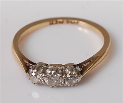 Lot 395 - An 18ct gold diamond three stone ring, the old...