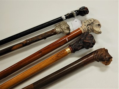 Lot 114 - An ebonised walking cane, the handle in the...