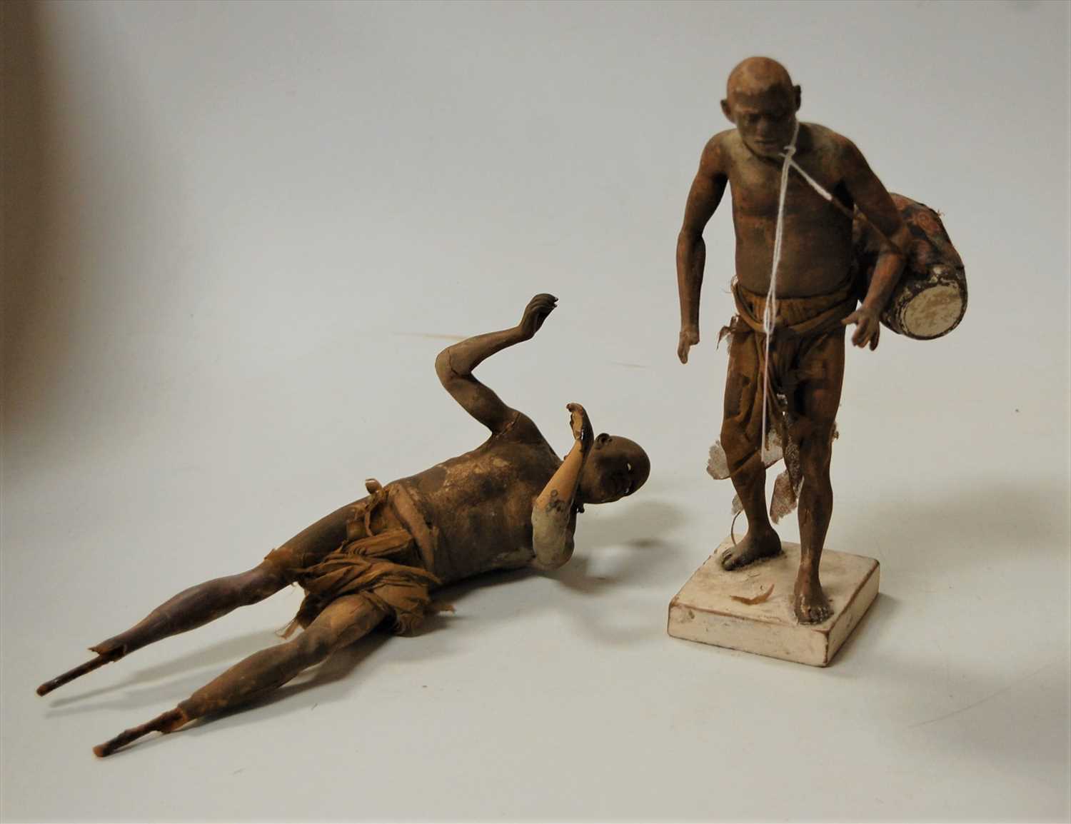 Lot 215 - A terracotta figure of an African man in...