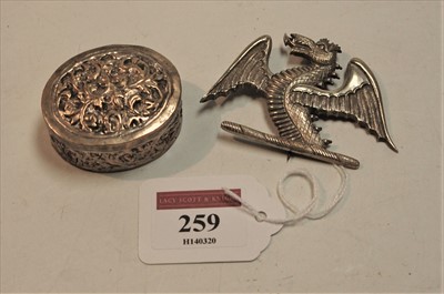 Lot 259 - A white metal badge in the form of a dragon...