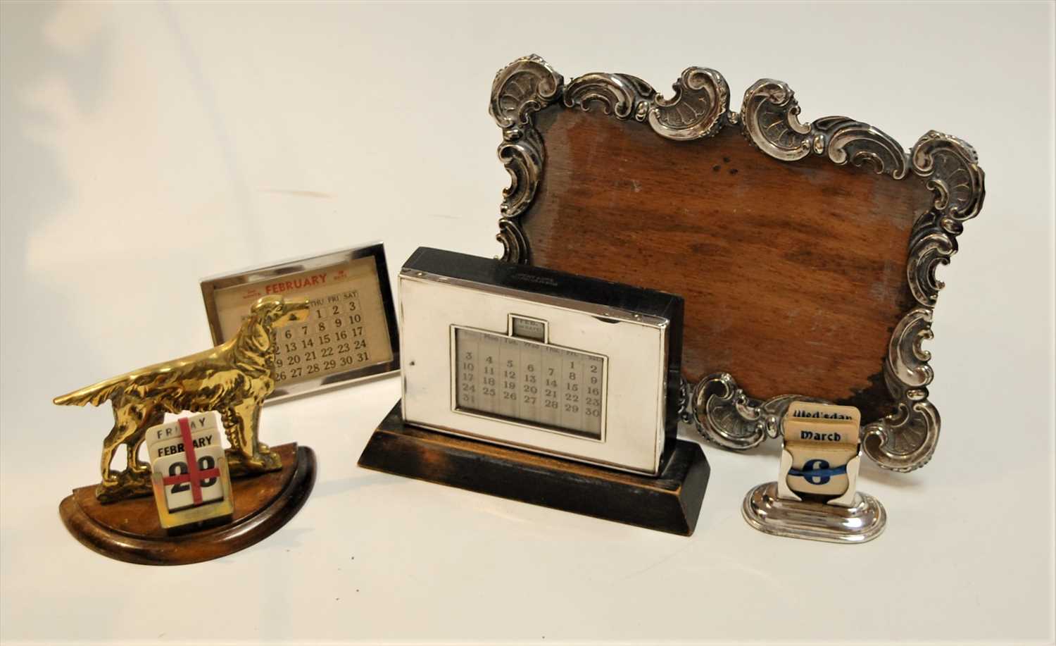 Lot 297 - A George V silver clad perpetual desk calendar,...