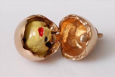 Lot 2207 - A 9ct yellow gold egg charm opening to reveal...