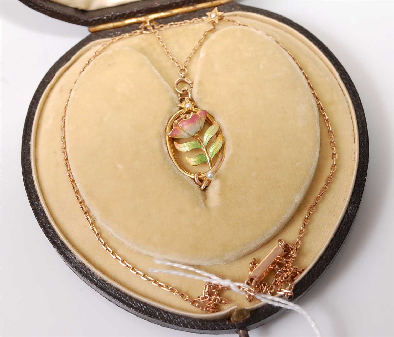 Lot 2209 - A rose and yellow metal oval pendant,...
