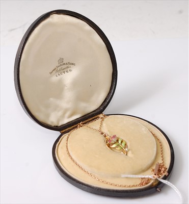 Lot 2209 - A rose and yellow metal oval pendant,...