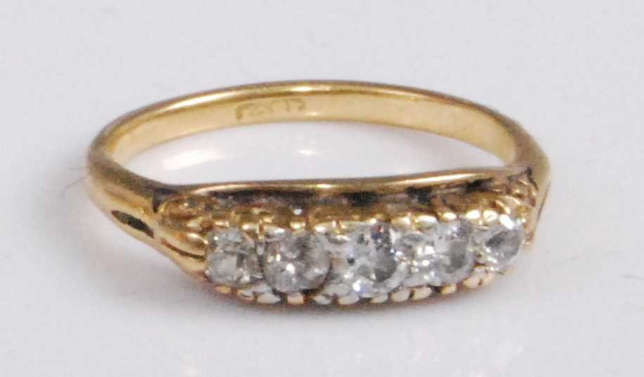 Lot 2056 - An 18ct gold diamond five-stone ring, the...