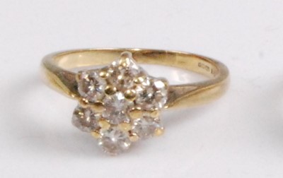 Lot 2084 - An 18ct gold diamond cluster ring, the seven...