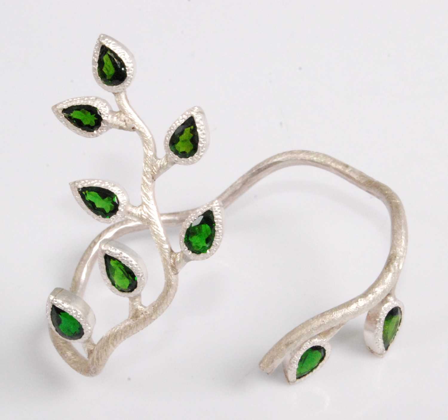 Lot 2090 - A contemporary silver and diopside bangle,...