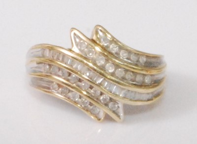 Lot 2179 - A contemporary 9ct gold diamond set dress ring,...