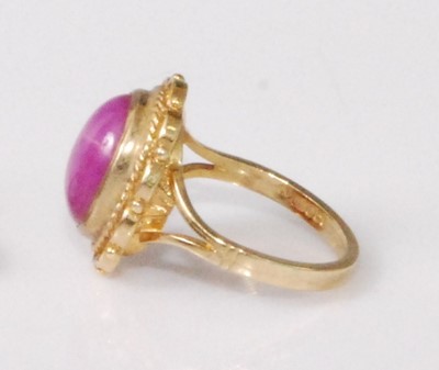 Lot 2190 - A 9ct gold 'synthetic' pink star sapphire set...