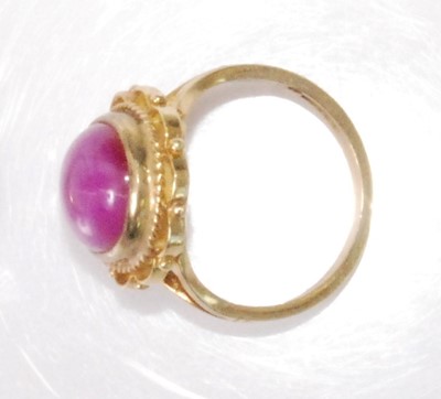 Lot 2190 - A 9ct gold 'synthetic' pink star sapphire set...