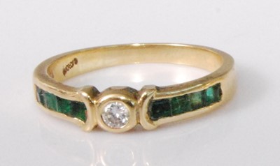 Lot 2229 - An 18ct gold, emerald and diamond half hoop...