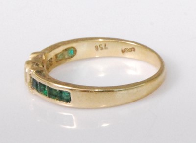 Lot 2229 - An 18ct gold, emerald and diamond half hoop...