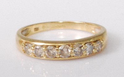 Lot 329 - An 18ct gold diamond half hoop ring, the seven...