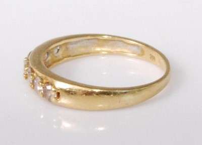 Lot 2230 - An 18ct gold diamond half hoop ring, the seven...