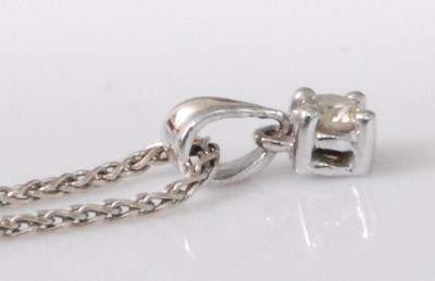 Lot 2241 - A platinum diamond set pendant, the four-claw...