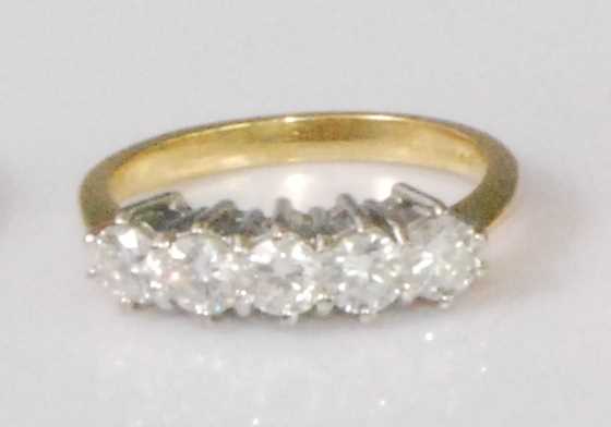 Lot 2259 - An 18ct gold diamond five stone ring, the claw...