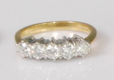 Lot 2259 - An 18ct gold diamond five stone ring, the claw...