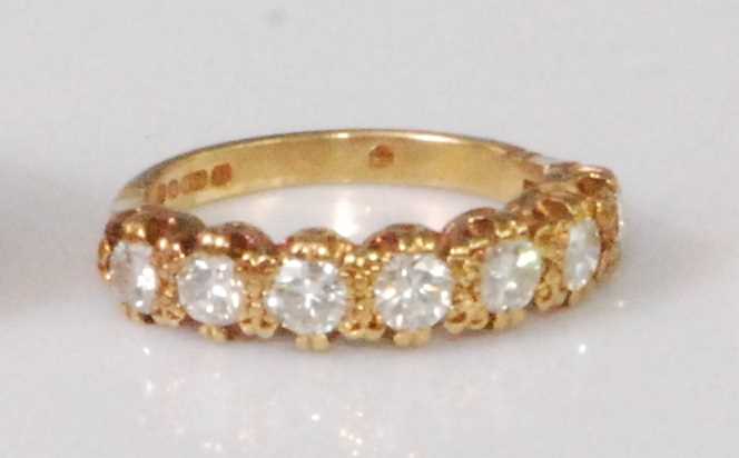 Lot 2261 - A contemporary 18ct gold diamond seven stone...