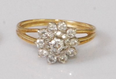 Lot 324 - A yellow metal diamond flowerhead cluster ring,...