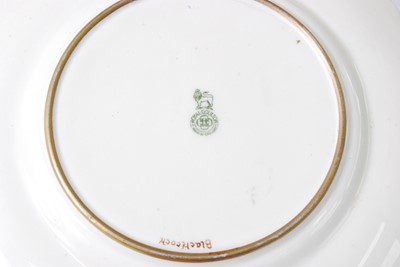Lot 1067 - A pair of Royal Doulton porcelain cabinet...