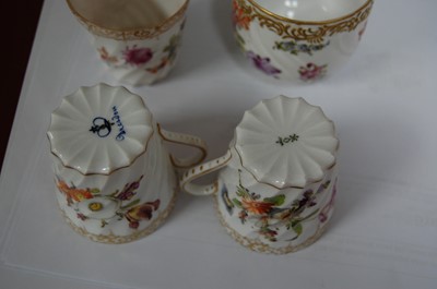 Lot 227 - A set of four Dresden porcelain coffee cans...