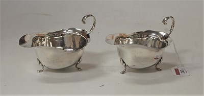 Lot 243 - A pair of 18th century style silver sauceboats,...