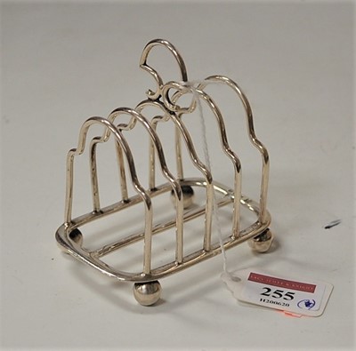 Lot 255 - An Edwardian silver four-division toast-rack,...