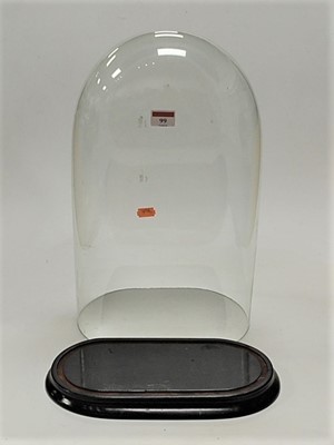 Lot 99 - A Victorian glass dome on associated ebonised...