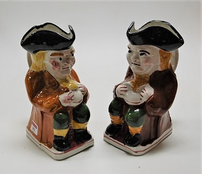 Lot 102 - A pair of Staffordshire style Toby jugs