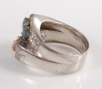 Lot 1192 - A white metal crossover ring, comprising a...