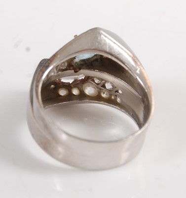 Lot 1192 - A white metal crossover ring, comprising a...