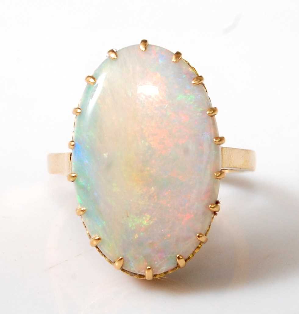 Lot 2503 - An 18ct yellow gold oval opal dress ring, the...