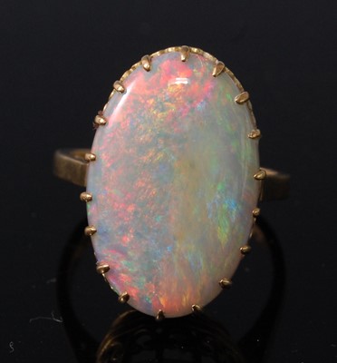 Lot 2503 - An 18ct yellow gold oval opal dress ring, the...