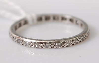 Lot 301 - A white metal diamond full hoop eternity ring,...