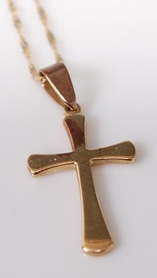 Lot 304 - A yellow metal cross pendant attached to a...