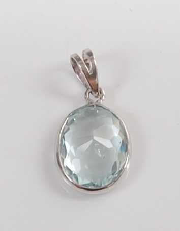 Lot 1198 - A white metal and aquamarine pendant, the oval...