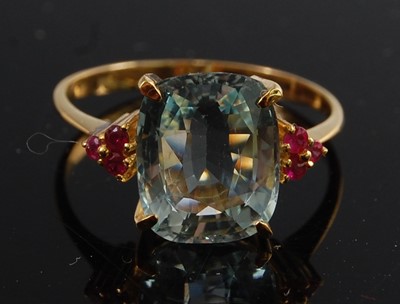 Lot 1193 - A yellow metal, aquamarine and ruby dress ring,...