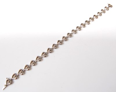 Lot 2506 - A 9ct white gold diamond line bracelet,...