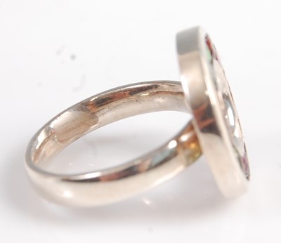 Lot 2574 - A white metal circular multi-stone ring,...