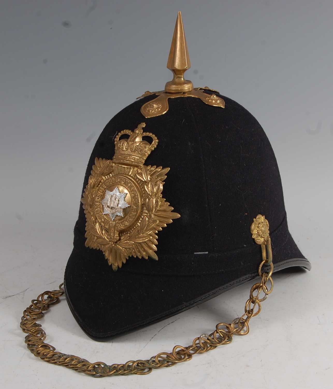 Lot 55 - A 20th century Royal Anglian blue cloth covered helmet