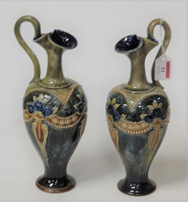 Lot 51 - A pair of Royal Doulton stoneware ewers, each...